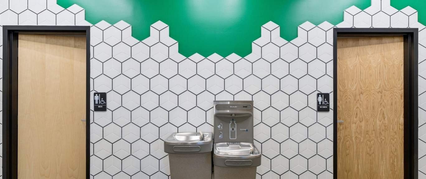 Foxhound Bee Company: Restroom corridor with honeycomb tile